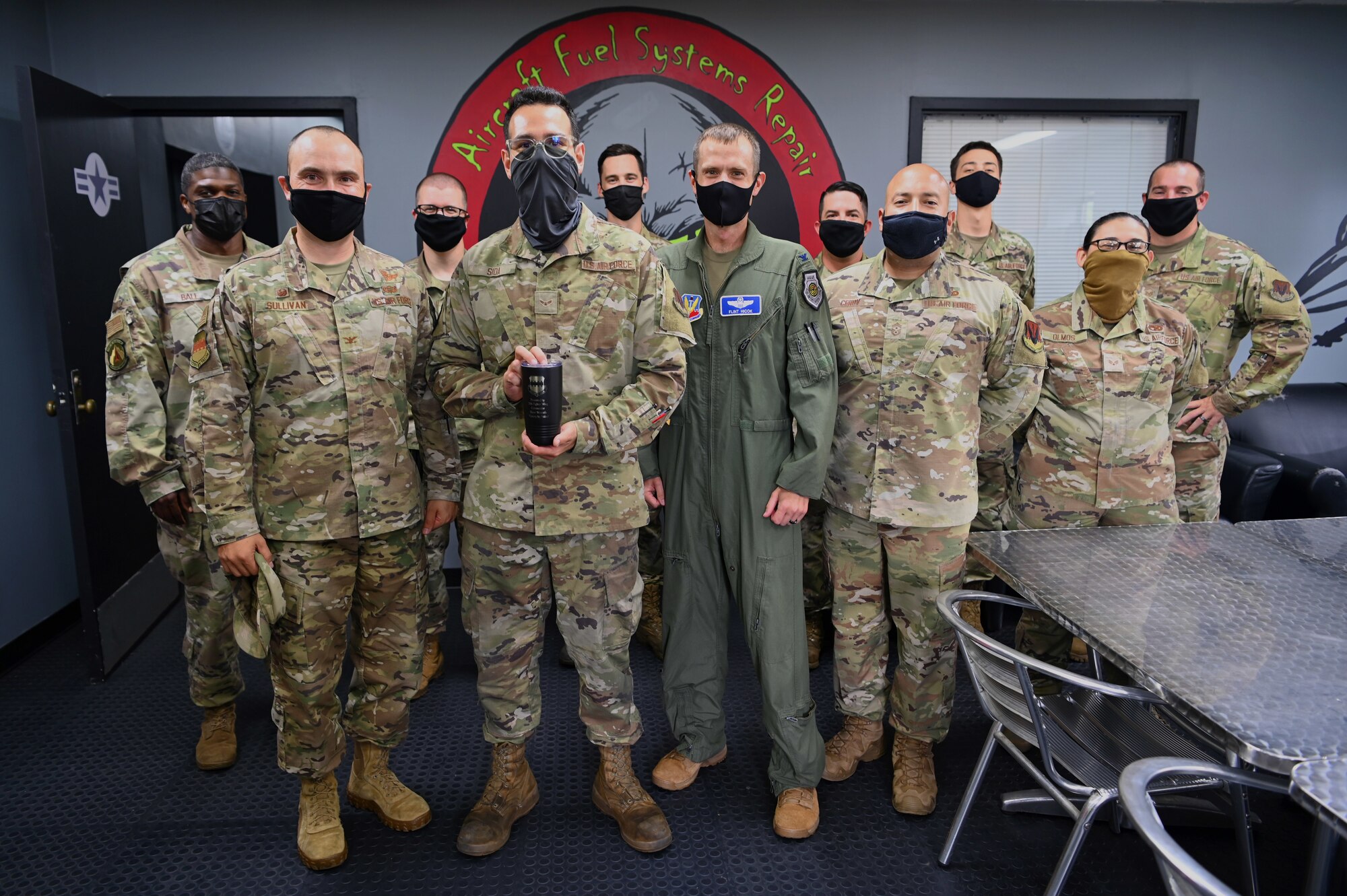 Airman and leadership pose for a group photo