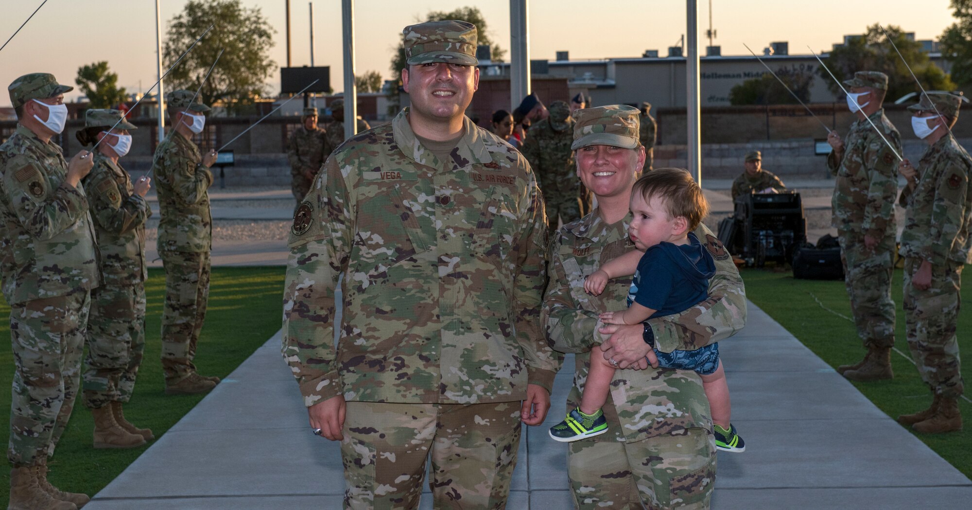 Master Sgt. Oscar Vega, 746th Test Squadron superintendent, left, and his wife, Master Sgt. Jackie Wolfe, Diagnostic and Therapeutic flight chief for the 49th Medical Support Squadron, are photographed during Vega’s Sept. 2, 2020, promotion ceremony at Holloman Air Force Base, N.M., where both have served for the past year-and-a-half. Also pictured is the couple’s son, Oscar Vega II. Vega and Wolfe were recently recognized with Air Force Achievement Medals for quickly coming to the aid of a man during an April shopping outing by administering CPR. (U.S. Air Force photo)