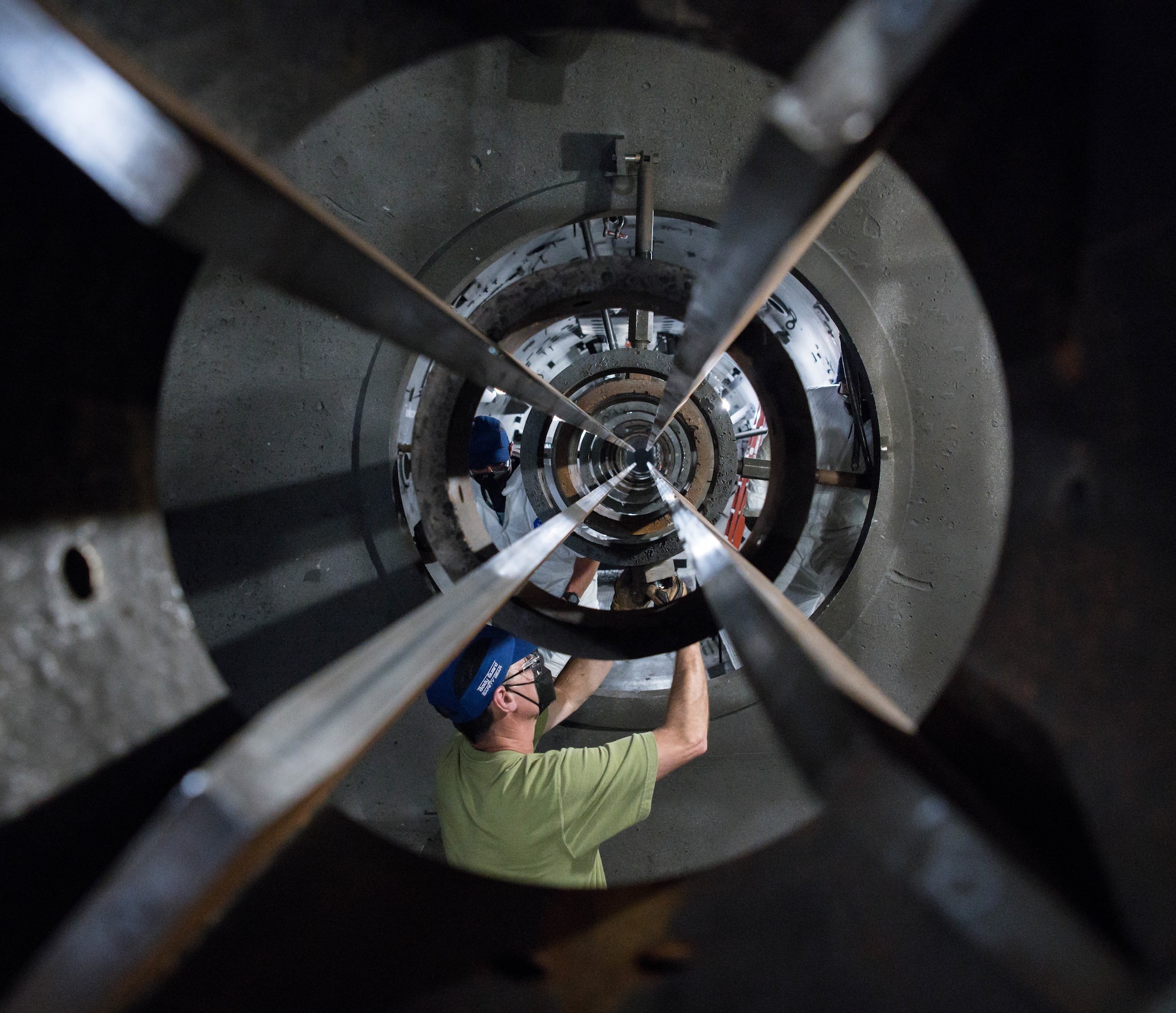 Tim Gilliam, an Arnold Engineering Development Complex machinist, adjusts a piece on the 8-inch track of the Hyper-ballistic Range G gun May 3, 2021, at Arnold Air Force Base, Tenn. After a projectile leaves the gun barrel it is guided by the track until within a short distance of the target. (U.S. Air Force photo by Jill Pickett)