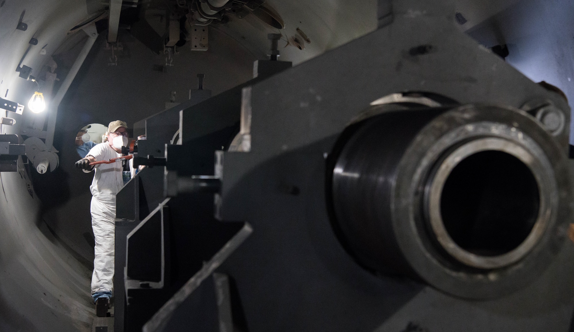 Mark Carson, an Arnold Engineering Development Complex lead machinist at Hyper-Ballistic Range G, slides a section of the 8-inch barrel for the Range G gun farther into the test tank to be connected and aligned with another section March 22, 2021, at Arnold Air Force Base, Tenn. (U.S. Air Force photo by Jill Pickett)