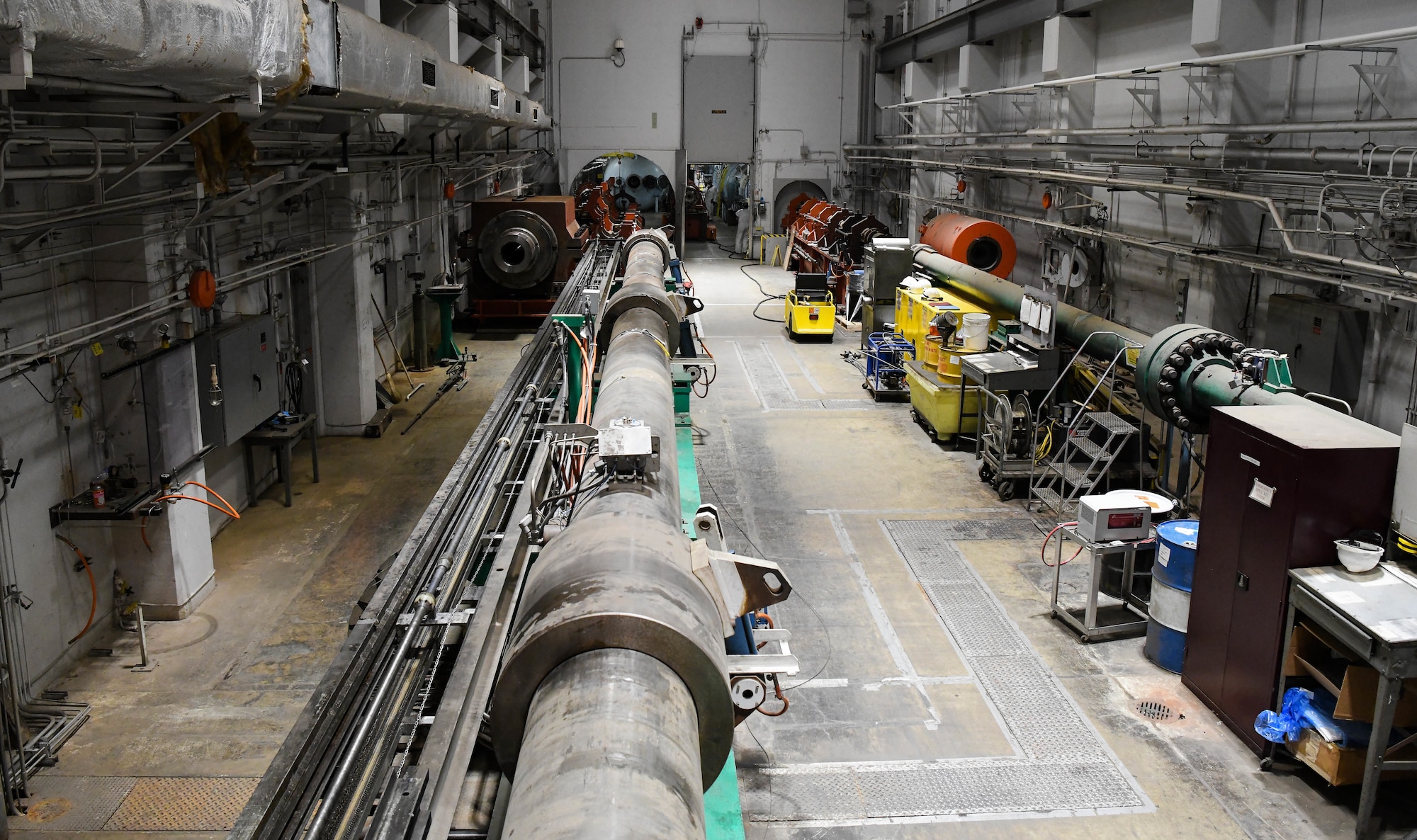 Hyper-ballistic Range G, left, seen here during a barrel change Feb. 23, 2021 at Arnold Air Force Base, Tenn., is used to conduct kinetic energy lethality and impact phenomenology testing. It is a two-stage light-gas gun system with a soft-launch capability for launching high-fidelity projectiles at hypervelocity speeds. (U.S. Air Force photo by Jill Pickett)