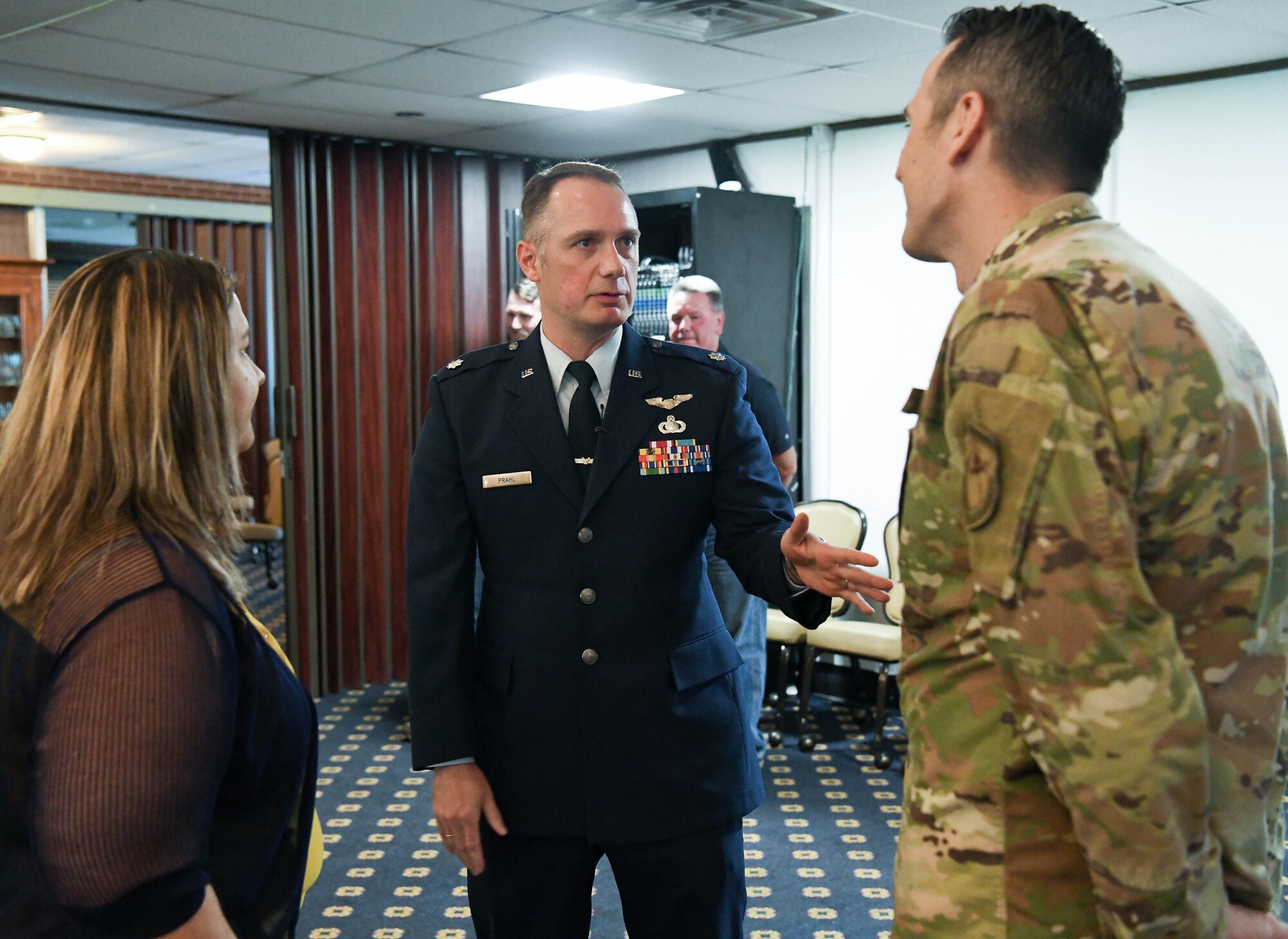 Following a Change of Leadership ceremony June 24, 2021, Lt. Col. Dayvid Prahl, center, Arnold Engineering Development Complex Space Test Branch chief, speaks to Melissa Tate, left, AEDC Propulsion Branch deputy, and Lt. Col. Lane Haubelt, right, AEDC Propulsion Branch chief, at the Arnold Lakeside Complex at Arnold Air Force Base, Tenn. (U.S. Air Force photo by Jill Pickett)