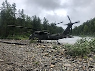 An Alaska Army National Guard UH-60L Black Hawk medevac helicopter from Detachment 2, G Company, 2nd Battalion, 211th Aviation Regiment, sits on a gravel sandbar at the headwater of the Yentna River, Alaska, about 70 miles northwest of Anchorage in a remote area that may only be accessed by aircraft or boat. Medevac aircrew from the AKNG provided emergency medical assistance and helicopter medical evacuation to a 75-year old man after he fell into a river and drowned, requiring immediate resuscitation and sustaining multiple injuries, Aug. 12, 2021.(Courtesy photo by U.S. Army National Guard crew chief, Staff Sgt. Bradley McKenzie)