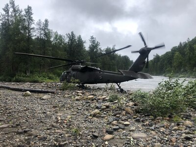 An Alaska Army National Guard UH-60L Black Hawk medevac helicopter from Detachment 2, G Company, 2nd Battalion, 211th Aviation Regiment, sits on a gravel sandbar at the headwater of the Yentna River, Alaska, about 70 miles northwest of Anchorage in a remote area that may only be accessed by aircraft or boat. Medevac aircrew from the AKNG provided emergency medical assistance and helicopter medical evacuation to a 75-year old man after he fell into a river and drowned, requiring immediate resuscitation and sustaining multiple injuries, Aug. 12, 2021.(Courtesy photo by U.S. Army National Guard crew chief, Staff Sgt. Bradley McKenzie)
