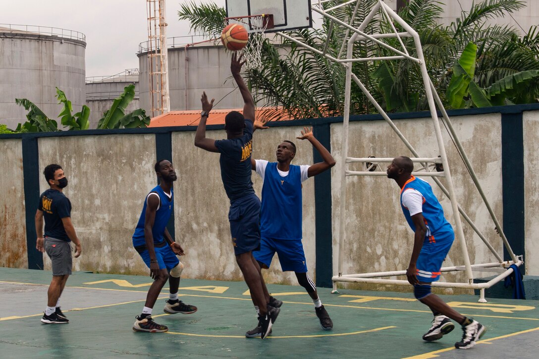 Sailors play basketball with members of the Nigerian navy.