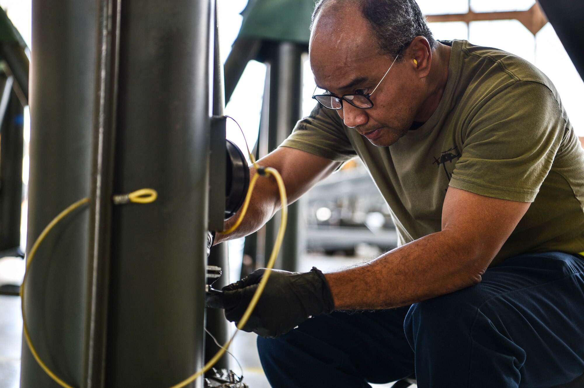 Amnadth Hamilton, 15th Maintenance Squadron aerospace ground equipment powered support systems mechanic, replaces a pressure gauge from a 60-ton aircraft jack in Hangar 15 at Joint Base Pearl Harbor-Hickam, Hawaii, Aug. 12, 2021. The AGE flight provides equipment such as hydraulic test stands, diesel generators, gas turbine generators, and more to support the several aircraft involved with JBPHH flight operations. (U.S. Air Force photo by Senior Airman Alan Ricker)