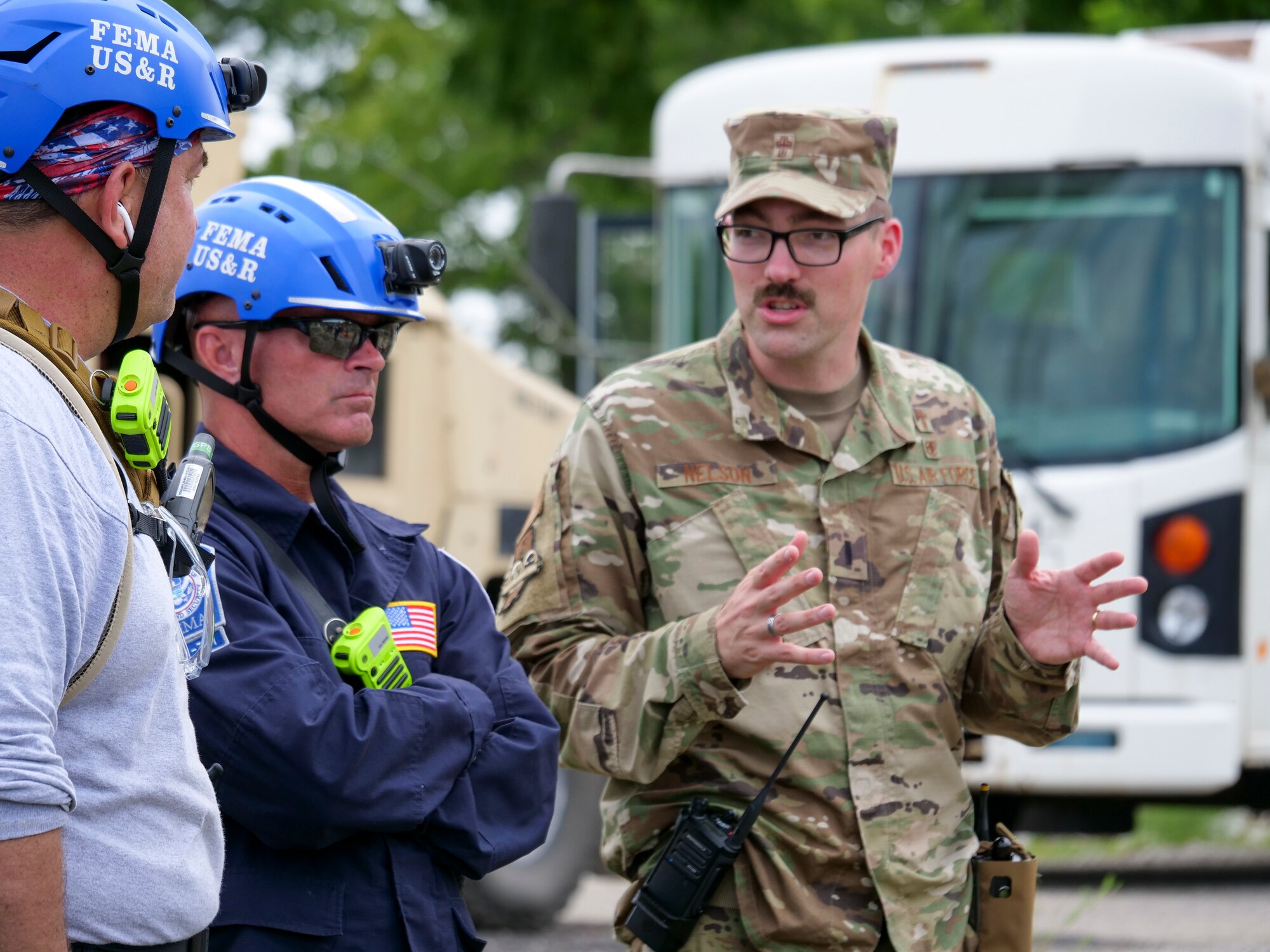 A member of the Indiana National Guard discusses mission plans with civilian counterparts during exercise Homeland Defender Aug. 14, 2021. More than 500 Soldiers, Airmen and civilian first responders participated in the scenario involving an earthquake and cyberattacks.