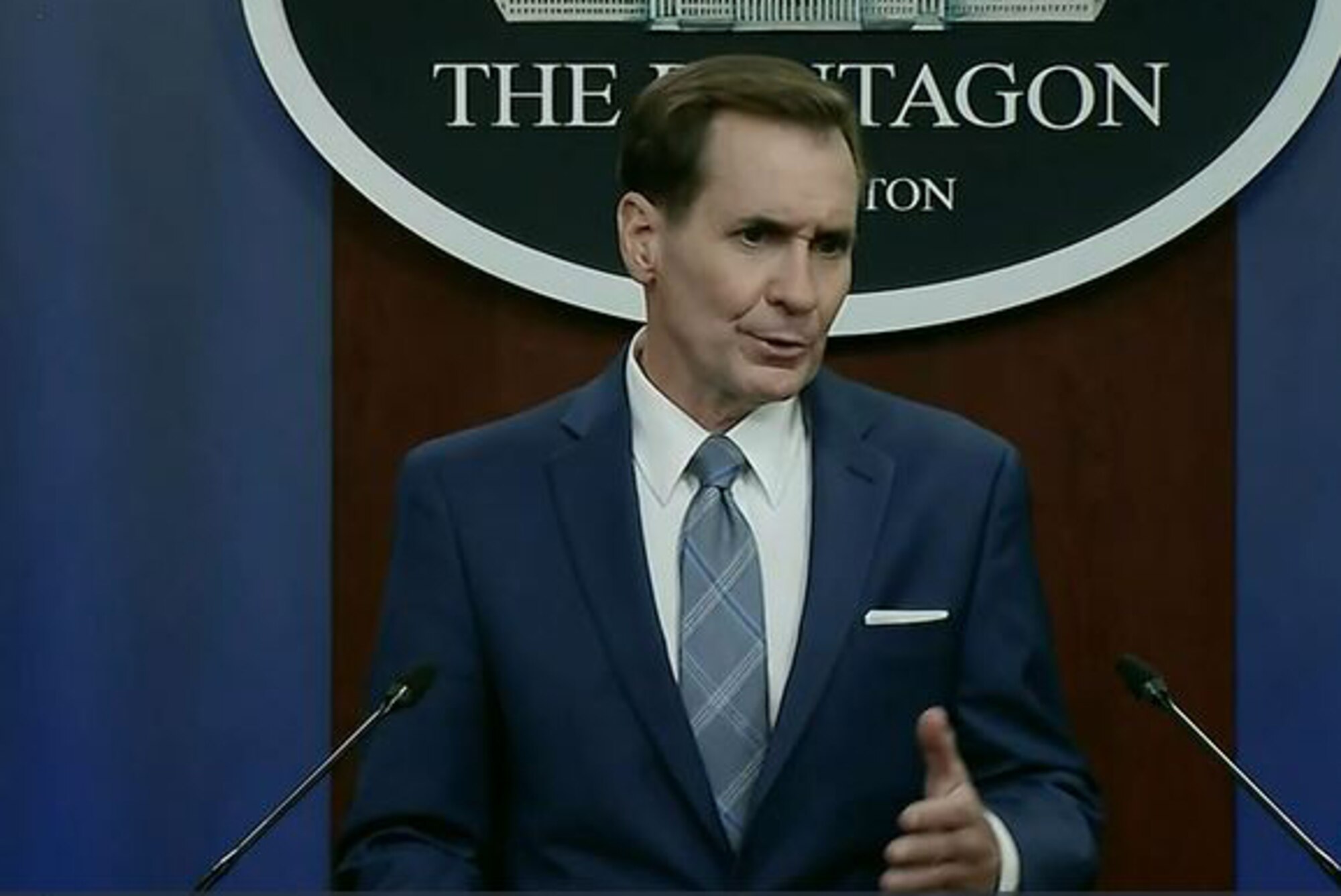 A man speaks at a podium.