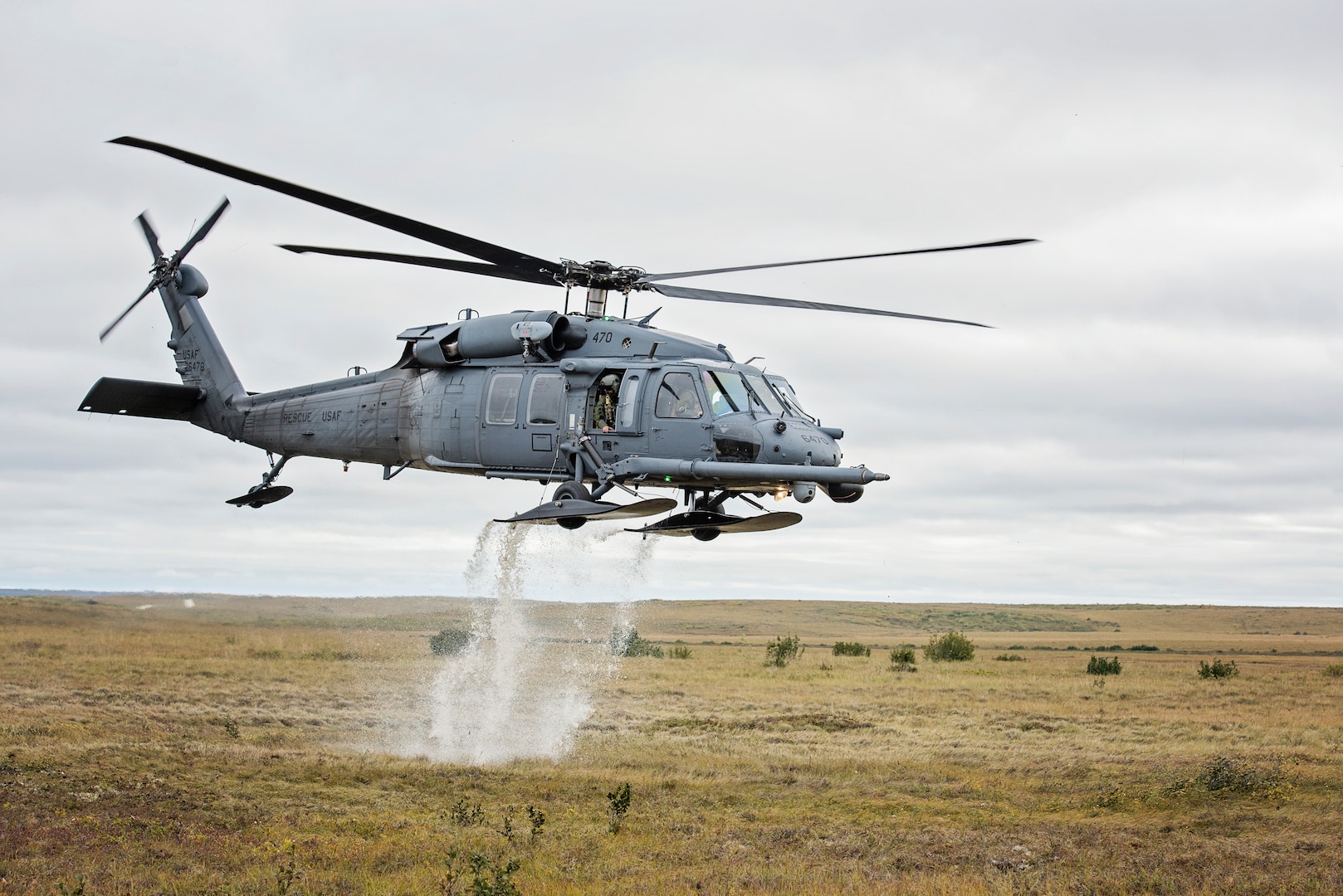 An HH-60 Pave Hawk helicopter from the 210th Rescue Squadron takes off from the tundra after loading simulated casualties during exercise Arctic Chinook, near Kotzebue, Alaska, Aug. 24, 2016.