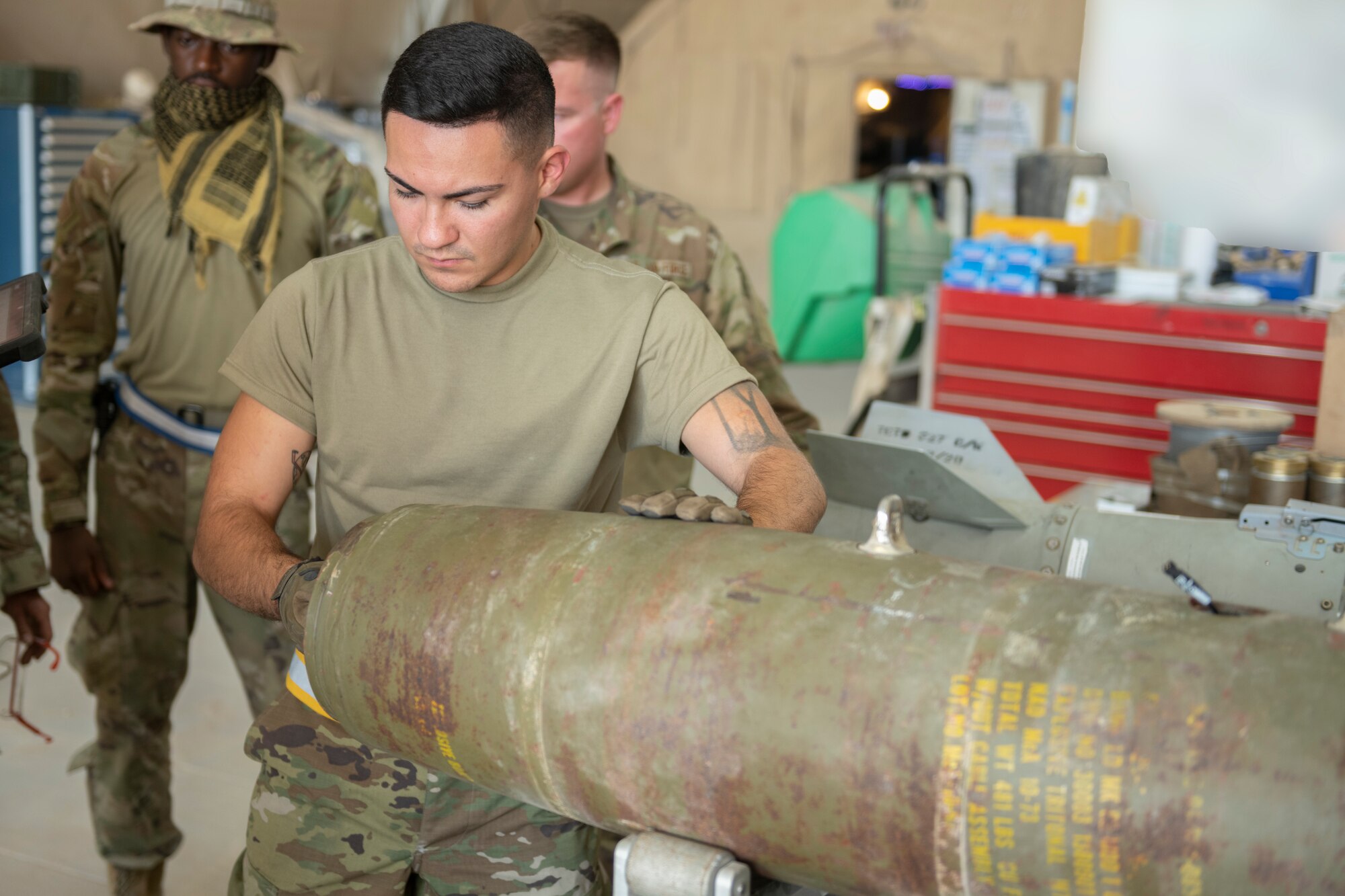 U.S. Air Force Airman 1st Class Aaron Klawitter, 332nd Expeditionary Maintenance Squadron stockpile crew chief, assembles a guided bomb unit August 14, 2021, in an undisclosed location somewhere in Southwest Asia. The 332nd EMXS creates and maintains the equipment use to execute missions across the area of responsibility. (U.S. Air Force Senior Airman Cameron Otte) (This image is blurred for security reasons)