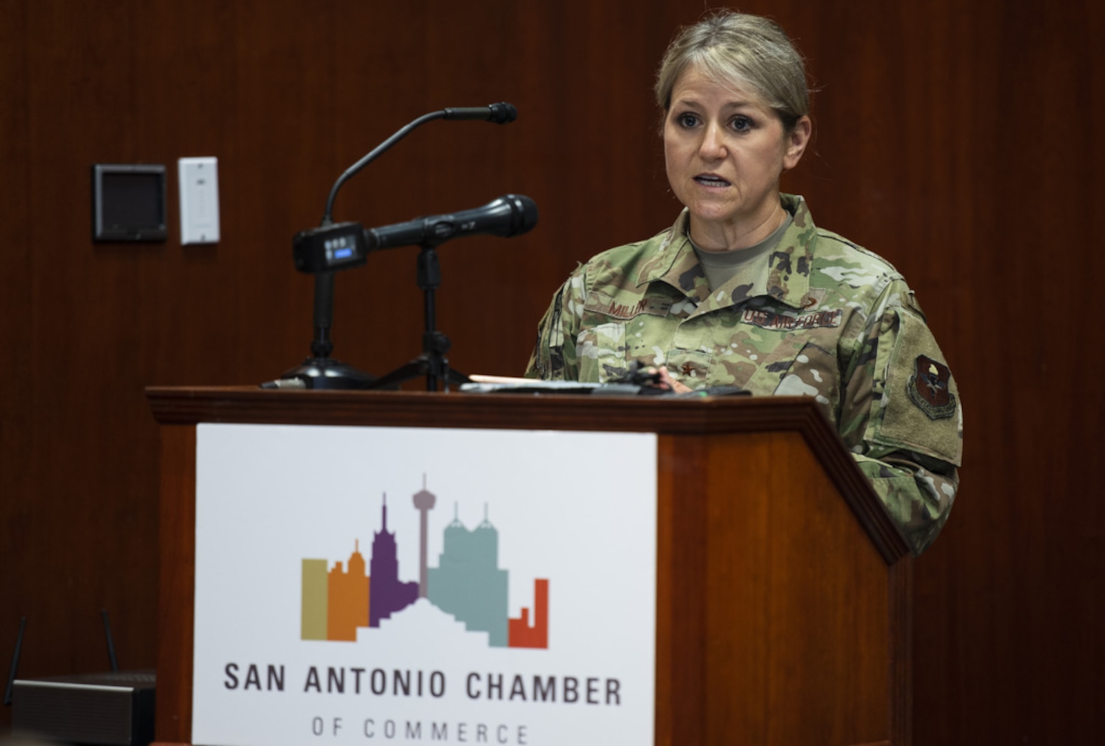 Woman stands at a podium giving remarks during a press conference.