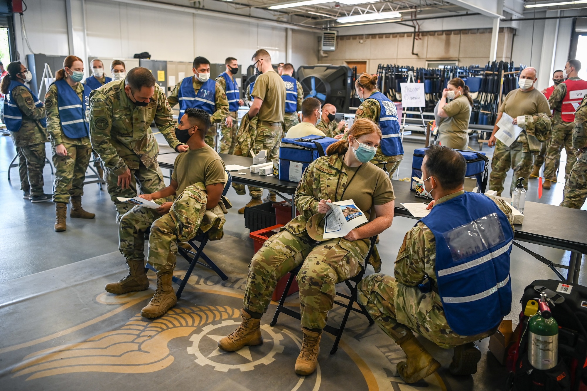 Members from 75th Medical Group simulate dispensing the anthrax vaccination Aug. 12, 2021, at Hill Air Force Base, Utah. The 75th MDG played out a mass-vaccination and medication dispersal scenario responding to an anthrax threat as part of Ready Eagle, an Air Force Medical Readiness Agency directed medical readiness training and exercise program. (U.S. Air Force photo by Cynthia Griggs)