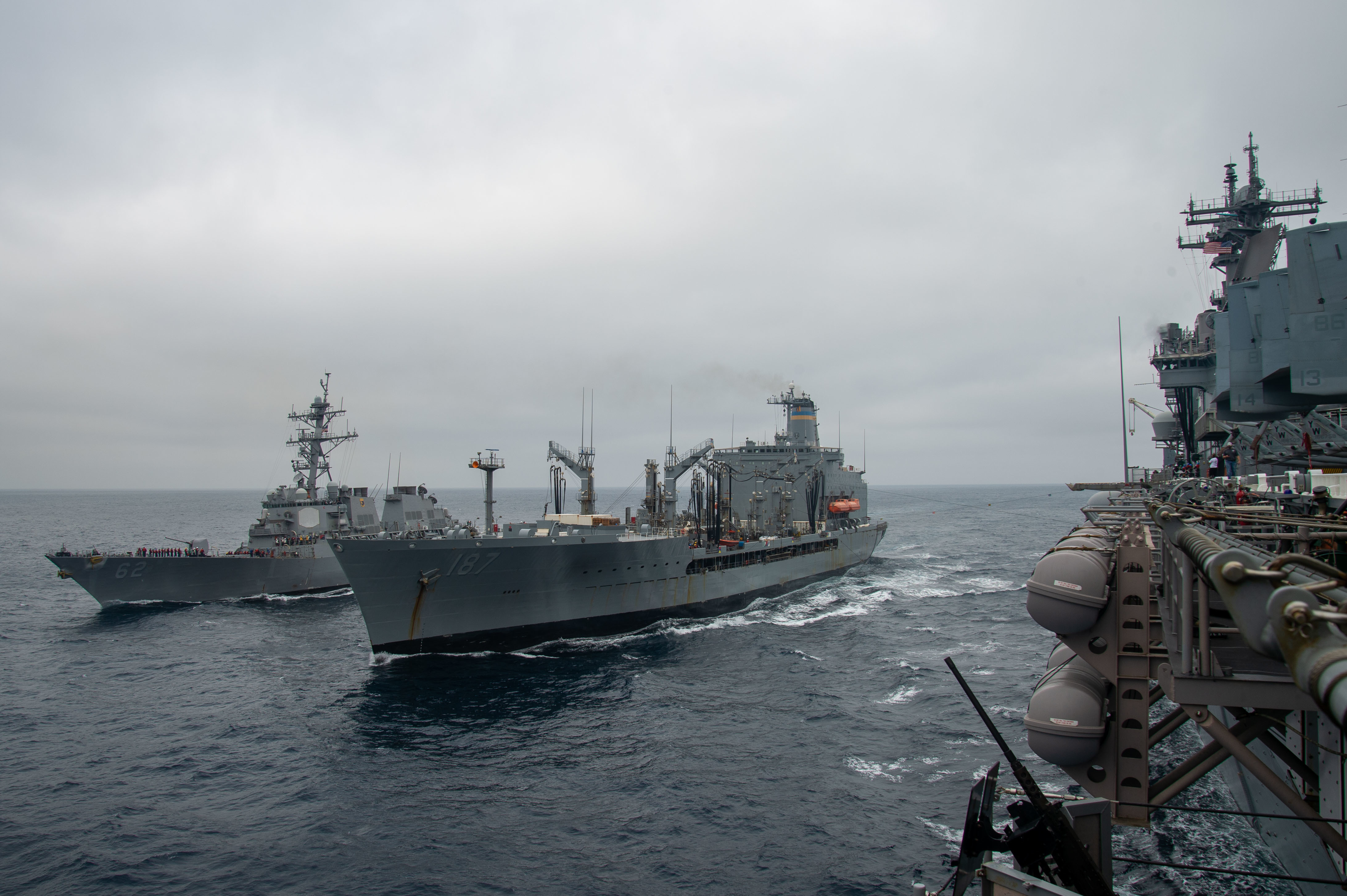 PACIFIC OCEAN (Aug. 15, 2021) The Arleigh Burke-class guided-missile destroyer USS Fitzgerald (DDG 62), left, and the Military Sealift Command fleet replenishment oiler USNS Henry J. Kaiser (T-AO 187), middle, transit alongside the Wasp-class amphibious assault ship USS Essex (LHD 2) during a replenishment-at-sea (RAS).