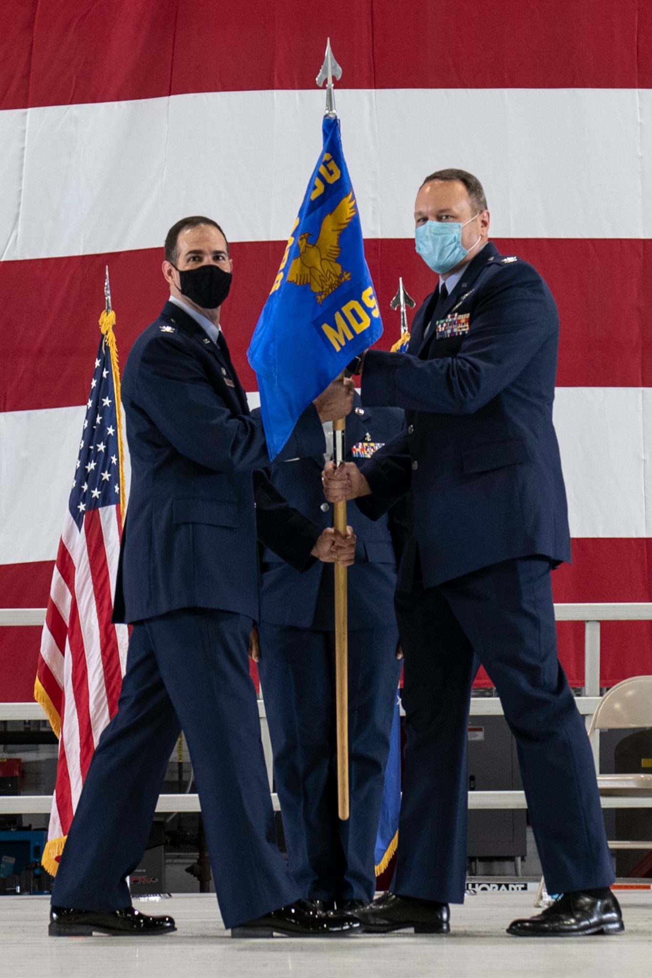 Col. Christopher Spinelli, 932nd Medical Group commander, passes the 932nd Medical Squadron guidon to Col. Sean Glasgow, incoming 932nd Medical Squadron commander, during the assumption of command ceremony August 7, 2021 at Scott Air Force Base, Illinois. Glasgow joins the 932nd AW from the Scott AFB Medical Center, where he served in the Ready Reserves as an individual mobilization augmentee. (U.S. Air Force photo by Staff Sgt. Brooke Spenner)