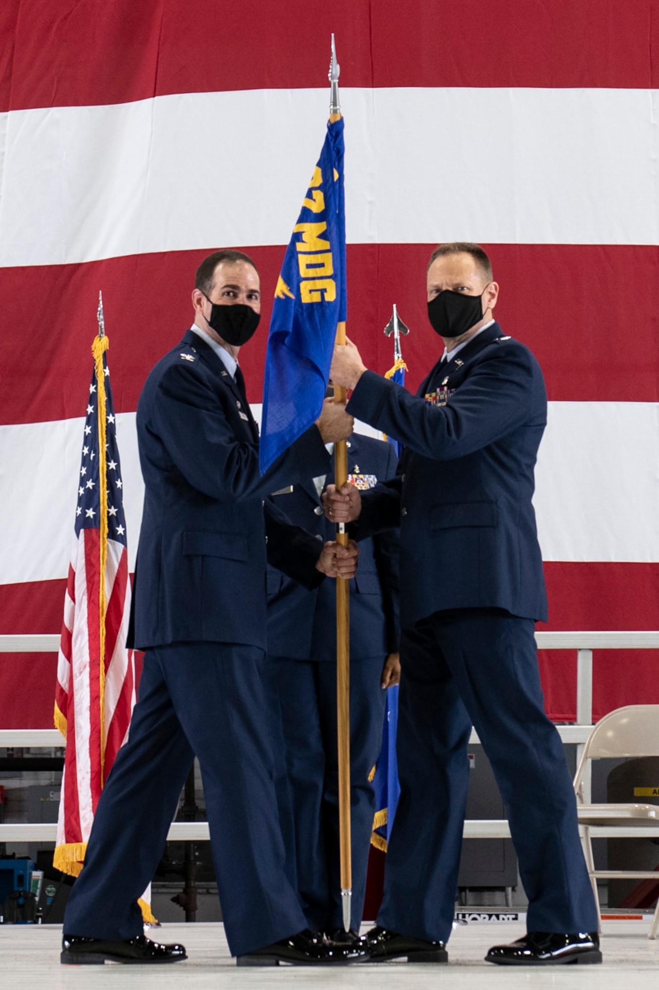 Col. Christopher Spinelli, 932nd Medical Group commander, passes the 932nd Medicine Squadron guidon to Lt. Col. Robert Garner, incoming 932nd Medicine Squadron commander, during the assumption of command ceremony August 7, 2021 at Scott Air Force Base, Illinois. Garner joins the 932nd AW from the U.S. Air Force Center for Sustainment of Trama and Resucitation Skills, where he served as a senior cadre member. (U.S. Air Force photo by Staff Sgt. Brooke Spenner)