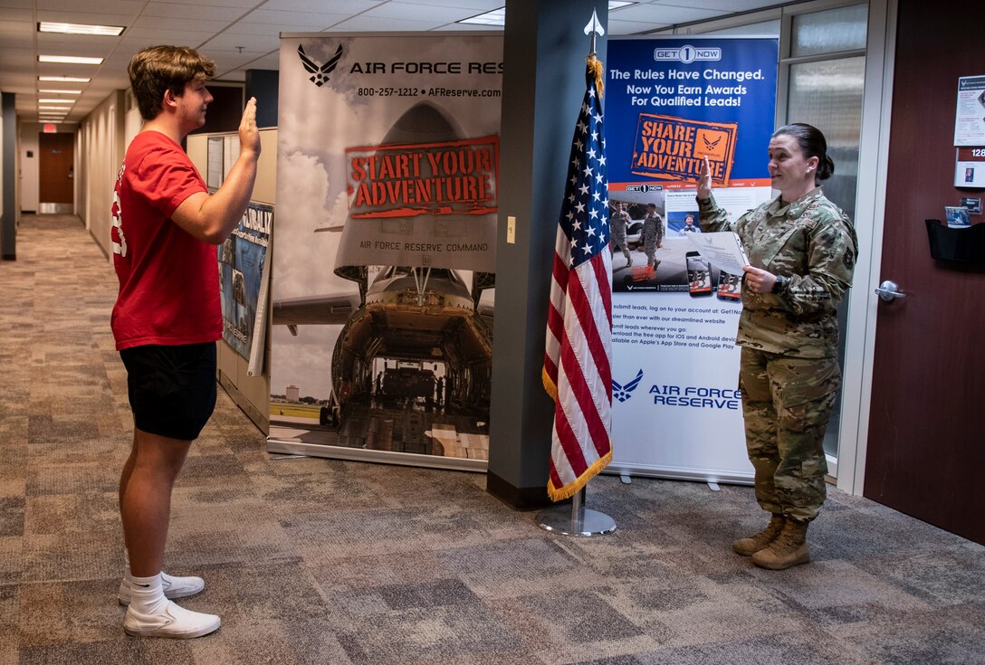 Carson Chenault recites the oath of enlistment on August 6, 2021, Scott Air Force Base, Ill. Chenault chose to be in security forces at Whitman AFB, Mo., he wanted to join the reserves for the educational benefits. (U.S. Air Force photo by SSgt. Brooke Spenner)
