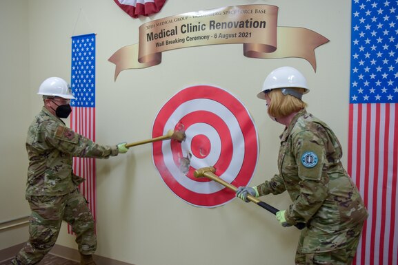 Col. Jessica Spitler, 30th Medical Group commander, and CMSgt. Luis Magana, 30th Medical Group superintendent, participate in the wall breaking ceremony at the 30th MDG building on Vandenberg Space Force Base, California, Aug. 6, 2021.
