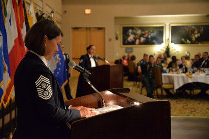 CMSAF stands at podium while NCO translates.