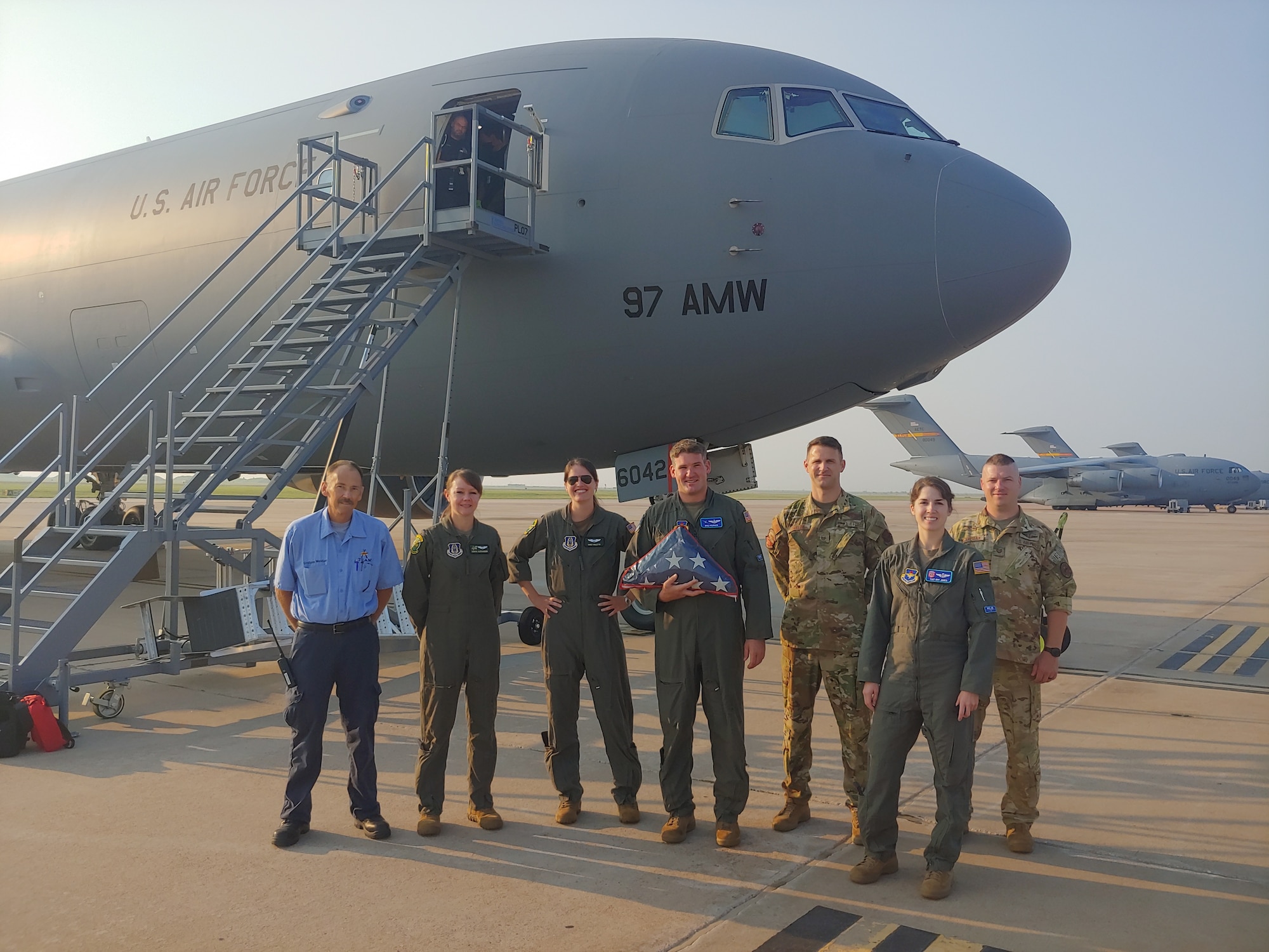 KC-46 Pegasus aircrew in front of a KC-46 with a flag at Altus Air Force Base, Oklahoma, Aug. 3, 2021.