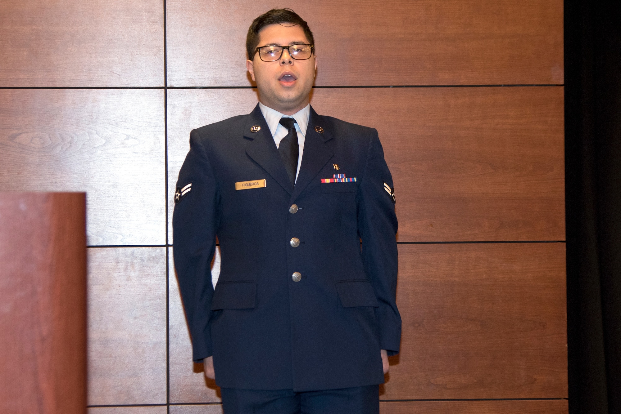 U.S. Air Force Airman 1st Class Jacob Figueroa, a 673d Medical Support Squadron medical laboratory technician, sings the National Anthem during the 32nd Annual Federal Services Dental Meeting at the Arctic Warrior Event Center at JBER, Alaska, Aug. 5, 2021.
