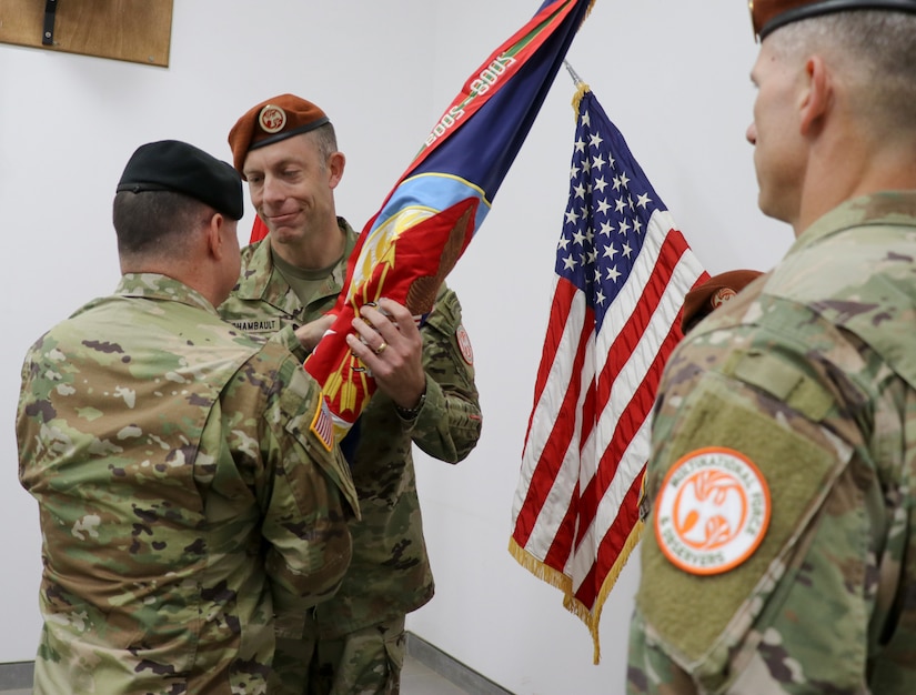 SINAI PENINSULA, Egypt – Col. Matthew Archambault (center), the incoming commander of Task Force Sinai, receives the brigade colors from Maj. Gen. Douglas Crissman (left), the deputy commanding general of U.S. Army Central, as the outgoing commander Col. Scott Sentell (right), the outgoing commander watches on, during a change of command ceremony held at the Multinational Force and Observers Headquarters Auditorium at South Camp, Sinai, Egypt August 15, 2021. During his 25-year career, Archambault has led units in both Iraq and Afghanistan and has taught at the U.S. Army School of Advanced Military Studies at Fort Leavenworth, Kansas.