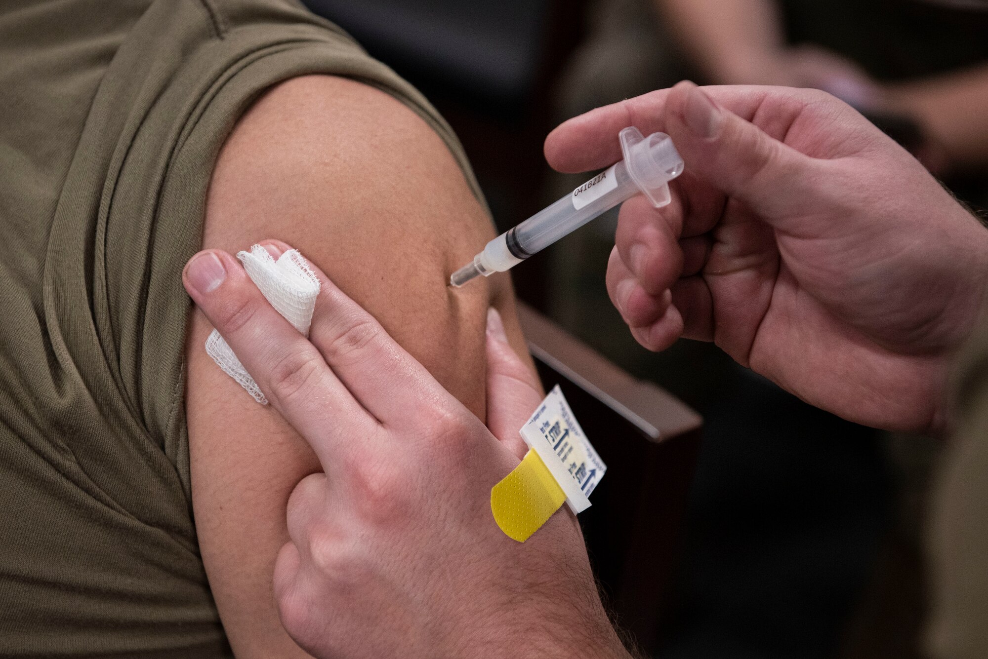A photo of an Airman receiving a vaccine.