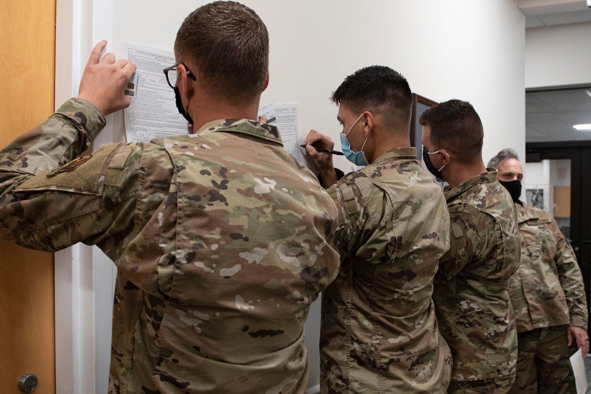 A photo of Airmen filling out medical forms.