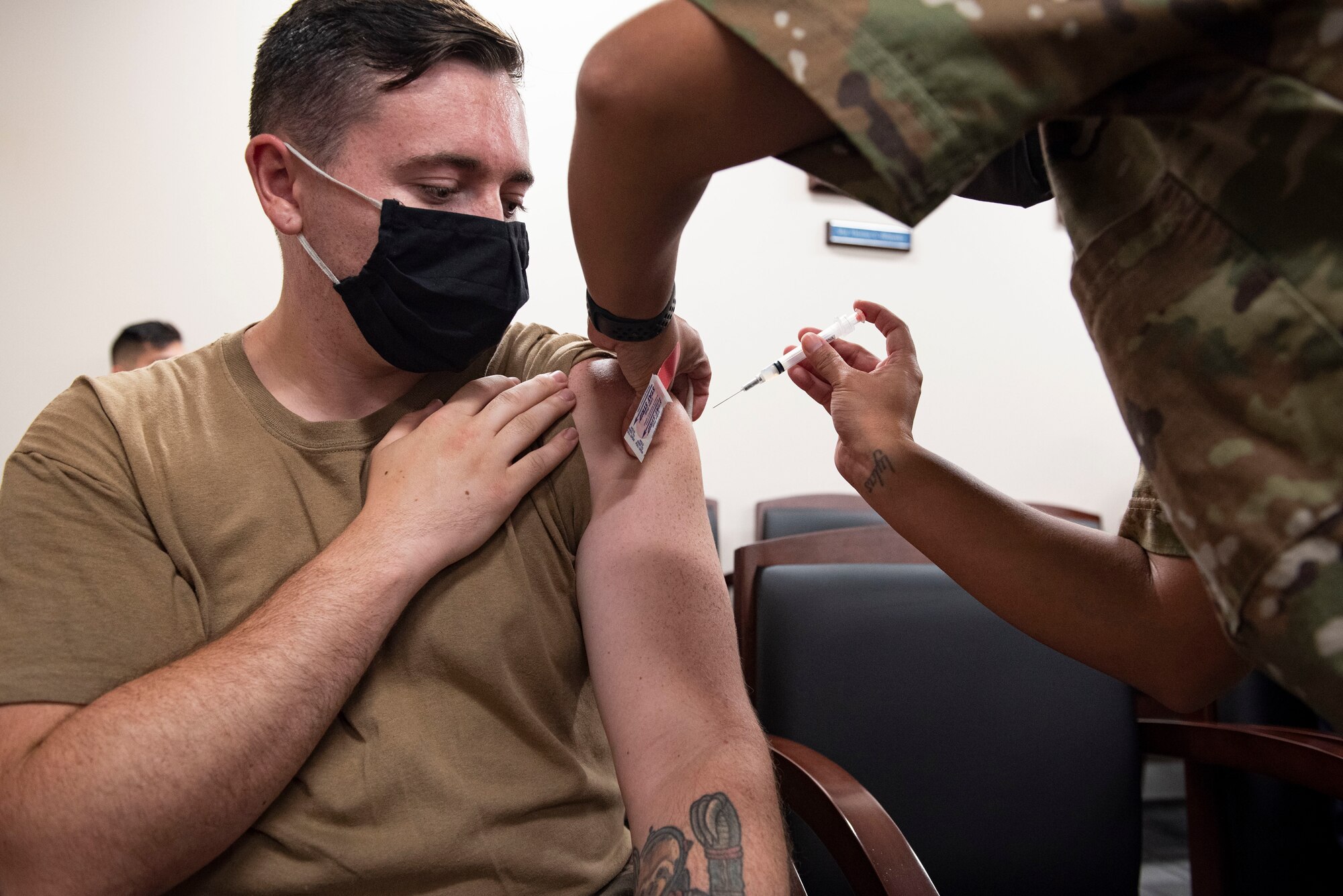 A photo of an Airman receiving a vaccine.