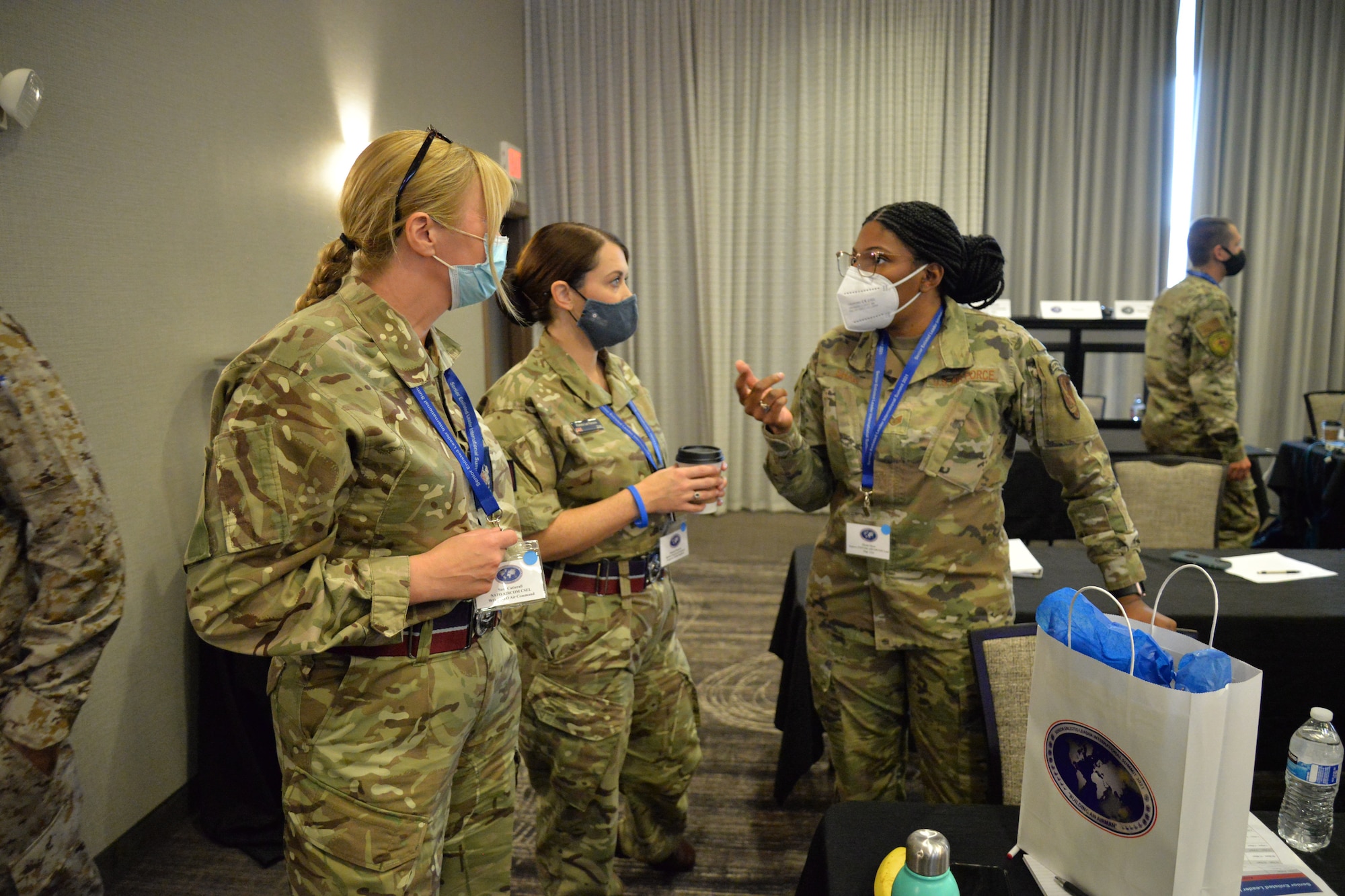 2 international enlisted leaders speak with an Air Force NCO.