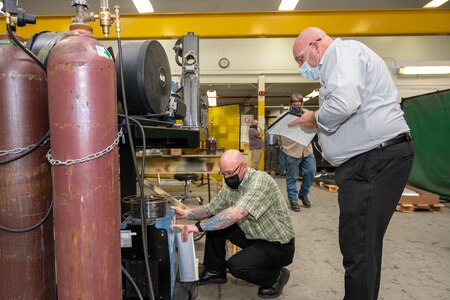 Photo of Barnes and Knecht examining equipment.
