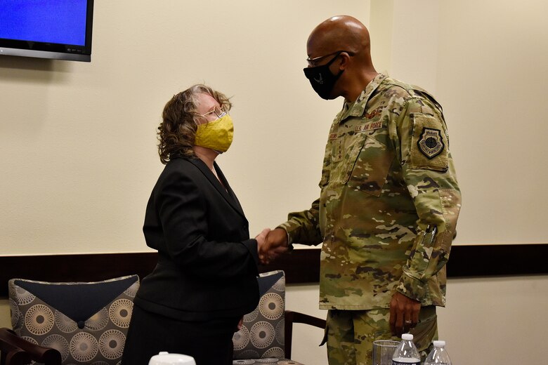 Dr. Stephanie Smith, Air Force Operational Test and Evaluation Center historian, receives a coin of excellence from Air Force Chief of Staff Gen. CQ Brown, Jr., during CSAF’s visit to the center at Kirtland Air Force Base, N.M., Aug. 12, 2021. Brown visited the course where both Air and Space Force students are taught how to plan, execute and report operational testing throughout the acquisition of combat capability.