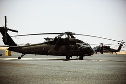 A UH-60 Blackhawk helicopter sits on the flight line at Camp Buehring, Kuwait, July 26, 2021. Nineteen Soldiers assigned to the 82nd Combat Aviation Brigade deployed to Kuwait to provide direct support to the 1100th Theater Aviation Support Maintenance Group and help alleviate a shortage of aviation contractors due to the COVID-19 pandemic. (U.S. Army photo by Sgt. Jimmie Baker)