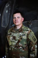 Sgt. 1st Class Carl Rothermel, maintenance noncommissioned officer in charge, 82nd Combat Aviation Brigade, stands in front of a UH-60 Blackhawk helicopter at Camp Buehring, Kuwait, July 26, 2021. Rothermel and 19 Soldiers from the 82nd Combat Aviation Brigade deployed to Kuwait to augment the 1100th Theater Aviation Support Maintenance Group and help alleviate a shortage of aviation contractors due to the COVID-19 pandemic. (U.S. Army photo by Sgt. Jimmie Baker)