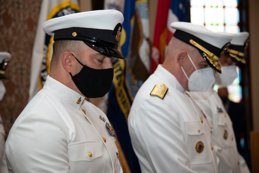 Students assigned to the Naval Chaplaincy School and Center, on Naval Station Newport, R.I., in the Basic Leadership Course, class 21030, lower their heads for the invocation during their graduation ceremony at the Chapel of Hope, Aug. 4. The Basic Leadership Course is a seven-week course which teaches basic knowledge of military chaplaincy as well as the fundamental skills to enable them to function effectively in a variety of sea service venues. (U.S. Navy photo by Mass Communication Specialist 2nd Class Derien C. Luce)