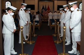 Students assigned to the Naval Chaplaincy School and Center, on Naval Station Newport, R.I., in the Basic Leadership Course, class 21030, lower their heads for the benediction during their graduation ceremony at the Chapel of Hope, Aug. 4. The Basic Leadership Course is a seven-week course which teaches basic knowledge of military chaplaincy as well as the fundamental skills to enable them to function effectively in a variety of sea service venues. (U.S. Navy photo by Mass Communication Specialist 2nd Class Derien C. Luce)