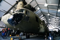 A CH-47 Chinook helicopter sits in a hanger awaiting phase maintenance at Camp Buehring, Kuwait, July 26, 2021. Phase maintenance can last anywhere between 25 and 45 days. Nineteen Soldiers assigned to the 82nd Combat Aviation Brigade deployed to Kuwait to provide direct support to the 1100th Theater Aviation Support Maintenance Group and help alleviate a shortage of aviation contractors due to the COVID-19 pandemic. (U.S. Army photo by Sgt. Jimmie Baker)
