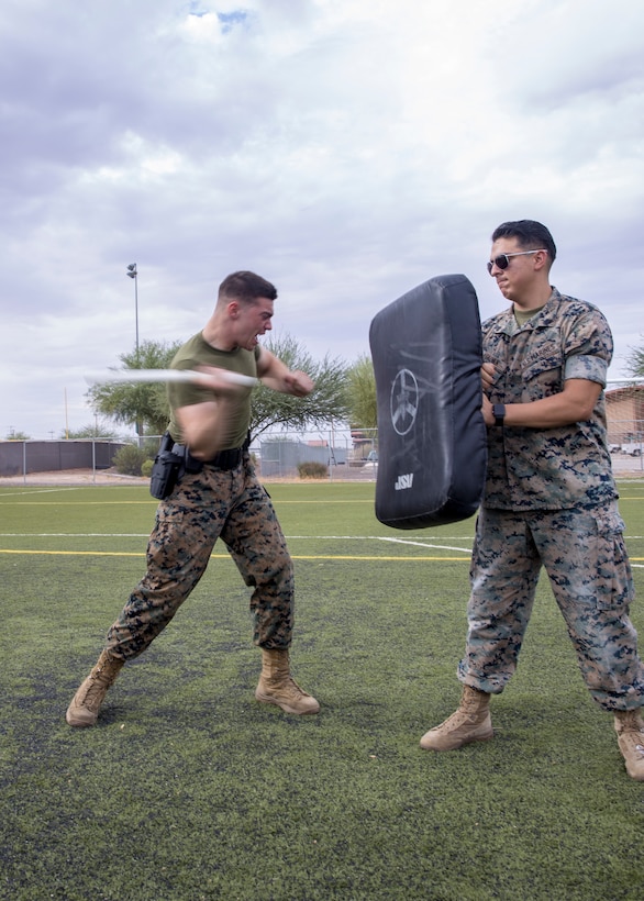 A U.S. Marine with the Provost Marshal Office fights back an aggressor during oleoresin capsicum spray training on Marine Corps Air Station Yuma, Ariz., July 30, 2021. After being sprayed, Marines were required to go through a series of obstacles in order to complete the course. (U.S. Marine Corps photo by Lance Cpl. Matthew Romonoyske-Bean)