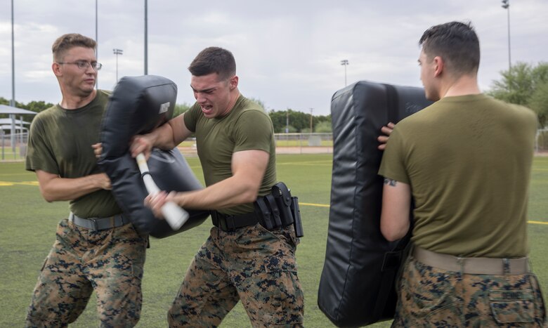 A U.S. Marine with the Provost Marshal Office fights back aggressors during oleoresin capsicum spray training on Marine Corps Air Station Yuma, Ariz., July 30, 2021. After being sprayed, Marines were required to go through a series of obstacles in order to complete the course. (U.S. Marine Corps photo by Lance Cpl. Matthew Romonoyske-Bean)