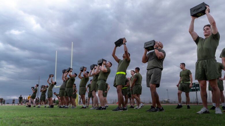 U.S. Marines from Headquarters and Headquarters Squadron (H&HS) participate in a squadron wide physical training (PT) event on Marine Corps Air Station Yuma, Ariz., July 30, 2021. H&HS holds monthly PT events to build comradery among the sections . (U.S. Marine Corps photo by LCpl. Matthew Romonoyske-Bean)