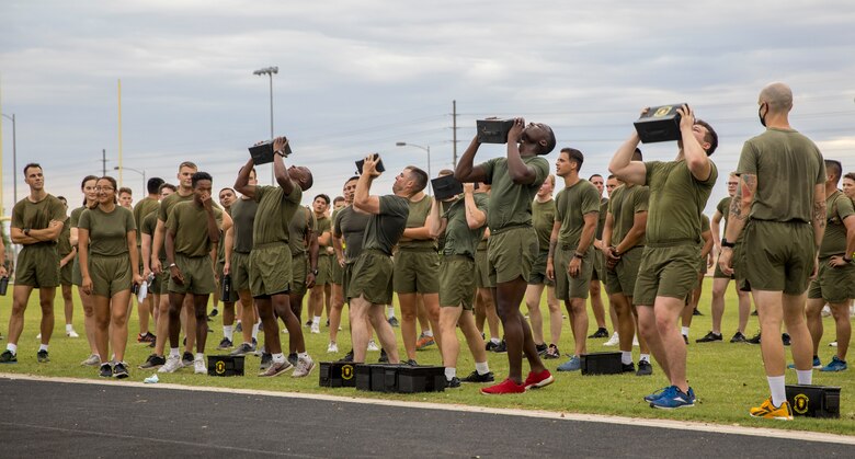 U.S. Marines from Headquarters and Headquarters Squadron (H&HS) participate in a squadron wide physical training (PT) event on Marine Corps Air Station Yuma, Ariz., July 30, 2021. H&HS holds monthly PT events to build comradery among the sections . (U.S. Marine Corps photo by LCpl. Matthew Romonoyske-Bean)