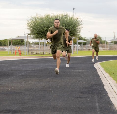 U.S. Marines from Headquarters and Headquarters Squadron (H&HS) participate in a squadron wide physical training (PT) event on Marine Corps Air Station Yuma, Ariz., July 30, 2021. H&HS holds monthly PT events to build comradery among the sections . (U.S. Marine Corps photo by LCpl. Matthew Romonoyske-Bean)