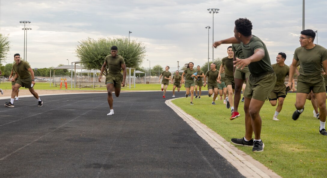 U.S. Marines from Headquarters and Headquarters Squadron (H&HS) participate in a squadron wide physical training (PT) event on Marine Corps Air Station Yuma, Ariz., July 30, 2021. H&HS holds monthly PT events to build comradery among the sections . (U.S. Marine Corps photo by LCpl. Matthew Romonoyske-Bean)