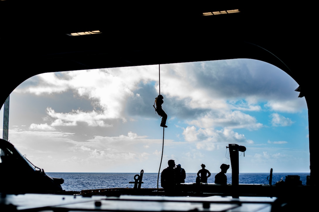 A U.S. Marine with Charlie Company, Battalion Landing Team 1/4, 15th Marine Expeditionary Unit fast-ropes from an MV-22 Osprey with Marine Medium Tiltrotor Squadron 164 (Reinforced), 15th MEU, aboard the amphibious assault ship USS Makin Island (LHD 8). The Makin Island Amphibious Ready Group and the 15th MEU are currently conducting routine operations in the U.S. 3rd Fleet area of operations. (U.S. Marine Corps photo by Lance Cpl. Mackenzie Binion)