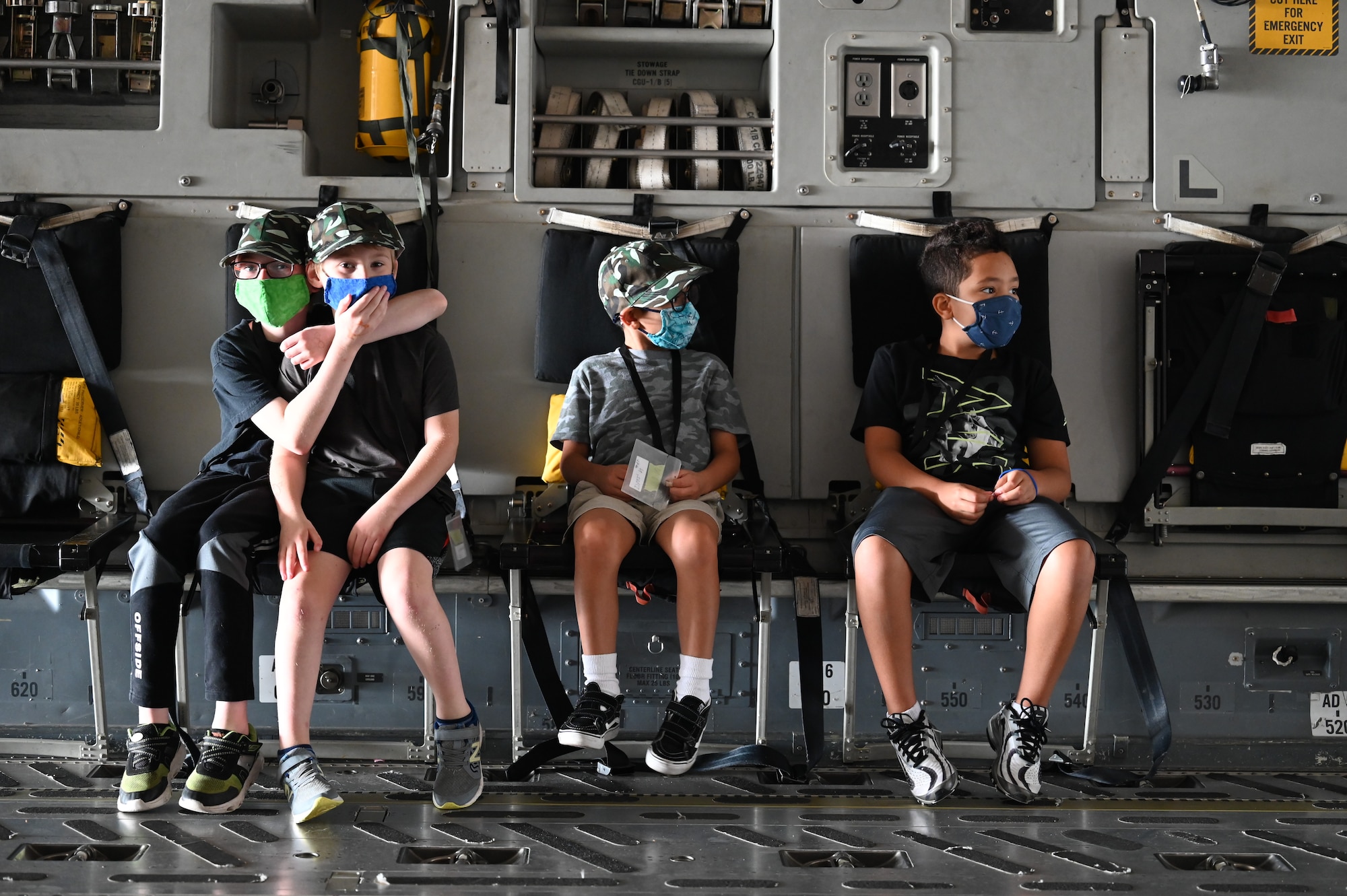Team McChord children wait inside a C-17 Globemaster III during Operation Kids Understanding Deployment Operations (KUDOs) at Joint Base Lewis-McChord, Washington, Aug. 14, 2021. More than 90 children, ages 4 to 14, participated in the mock deployment. (U.S. Air Force photo by Master Sgt. Julius Delos Reyes)