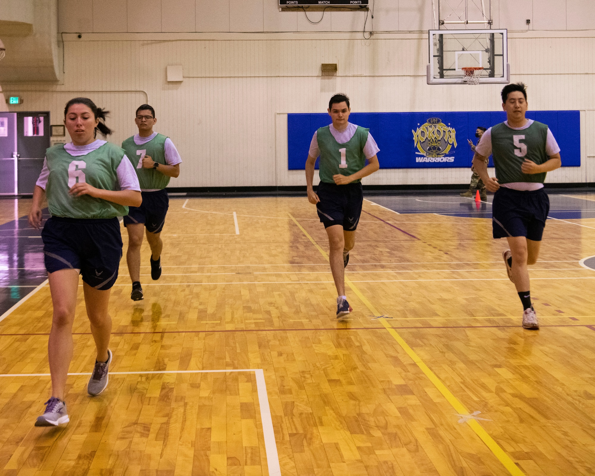 Members of the 374th Contracting Squadron perform High Aerobic Multi-shuttle Run during a mock test at Yokota Air Base, Japan, Aug. 13, 2021. The HAMR is one of five new components the Air Force offers for the updated fitness assessment. (U.S. Air Force photo by Staff Sgt. Braden Anderson)