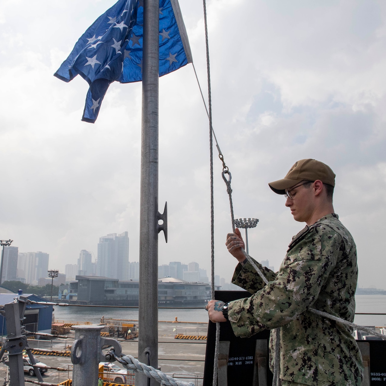 Operations Specialist 2nd Class Andrew Weimer, from Dallas, raises a union jack during a sea and anchor detail aboard Independence-variant littoral combat ship USS Charleston (LCS 18), Aug. 16. Charleston, part of Destroyer Squadron Seven, is on a rotational deployment operating in the U.S. 7th Fleet area of operation to enhance interoperability with partners and serve as a ready-response force in support of a free and open Indo-Pacific region.