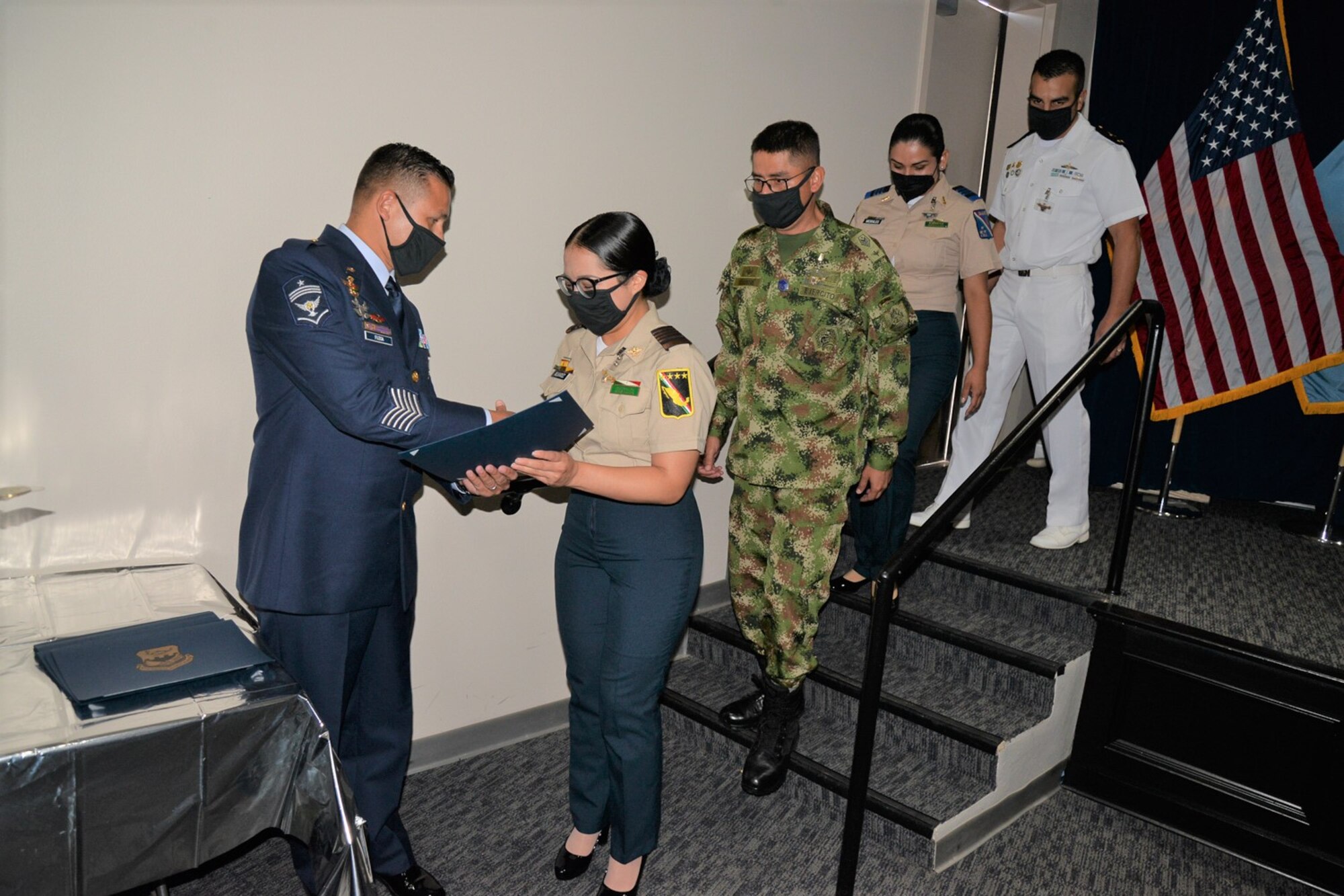 Members of the Inter-American Air Forces Academy’s Class 2021-B receive their graduation certificates at the ceremony Aug. 10, 2021, at Joint Base San Antonio-Lackland, Texas. Class 2021-B was the largest in-person class to graduate from the IAAFA since the COVID-19 pandemic struck approximately 17 months ago.
