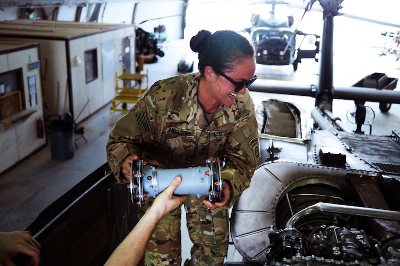 Sgt. Jerylee Papatsoris, UH-60 helicopter repairer, 82nd Combat Aviation Brigade, takes part in phase maintenance at Camp Buehring, Kuwait, July 26, 2021. Papatsoris deployed to Kuwait to provide direct support to the 1100th Theater Aviation Support Maintenance Group and help alleviate a shortage of aviation contractors due to the COVID-19 pandemic. (U.S. Army photo by Sgt. Jimmie Baker)