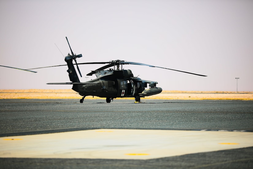 A UH-60 Blackhawk medical evacuation helicopter sits on the flight line at Camp Buehring, Kuwait, July 26, 2021. Nineteen Soldiers assigned to the 82nd Combat Aviation Brigade deployed to Kuwait to provide direct support to the 1100th Theater Aviation Support Maintenance Group and help alleviate a shortage of aviation contractors due to the COVID-19 pandemic. (U.S. Army photo by Sgt. Jimmie Baker)