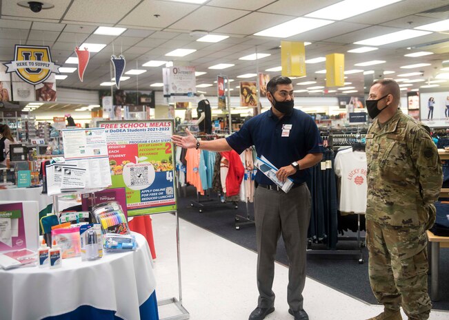 A BX worker welcomes a military member to the BX.